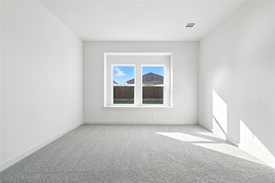 Carpeted empty room featuring baseboards Carpeted empty room featuring baseboards