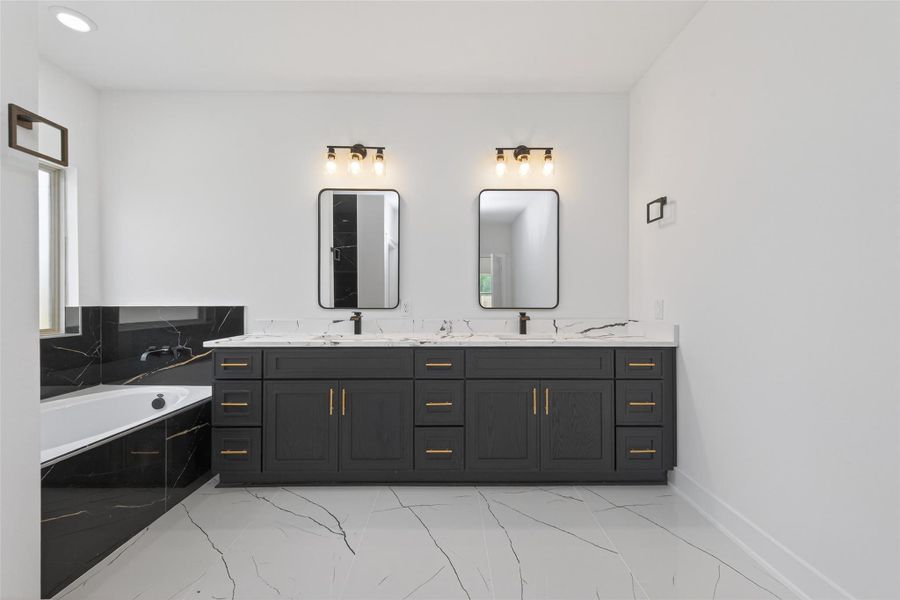 Spa-inspired primary bath with double-sink vanity, soaking tub, walk-in shower, and modern finishes.