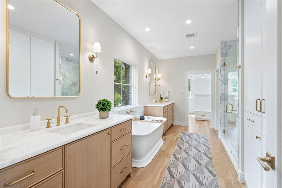 Bathroom with separate shower and tub, double sink vanity, and hardwood / wood-style floors