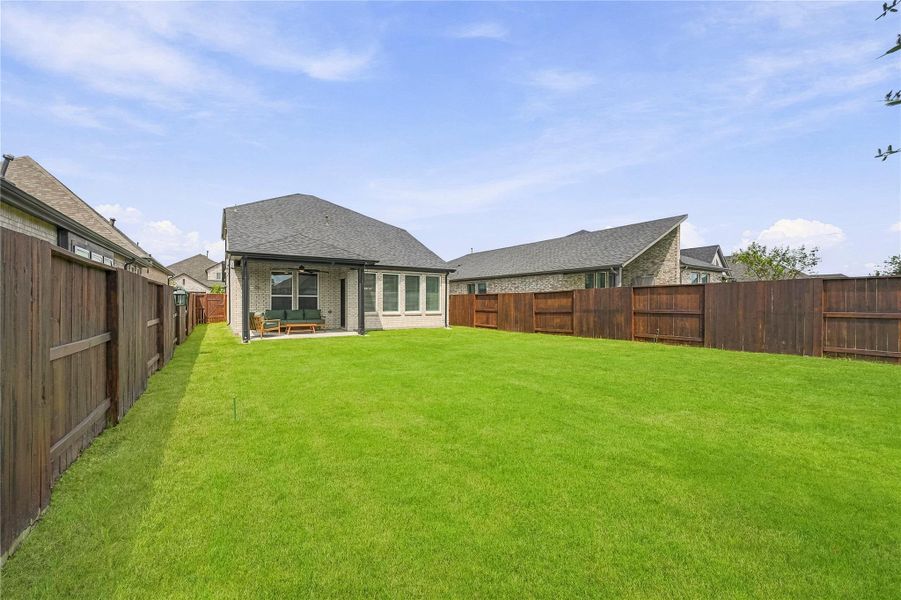 A covered back patio provides a comfortable spot to enjoy the outdoors while overlooking the expansive, fully fenced backyard with ample room to personalize the space. A covered back patio provides a comfortable spot to enjoy the outdoors while overlooking the expansive, fully fenced backyard with ample room to personalize the space.