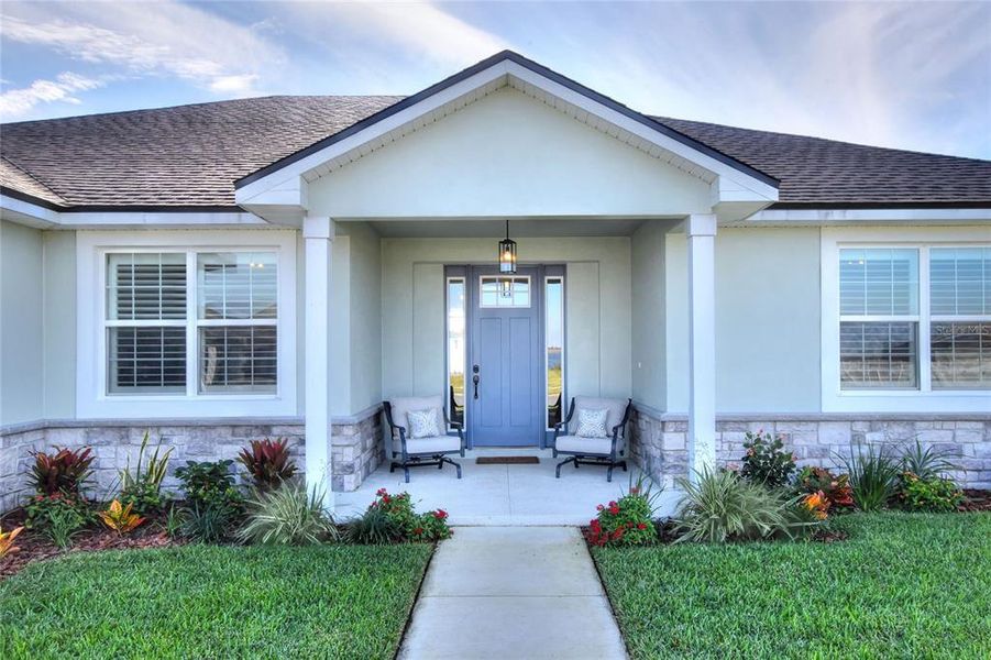 Front door and porch of property.