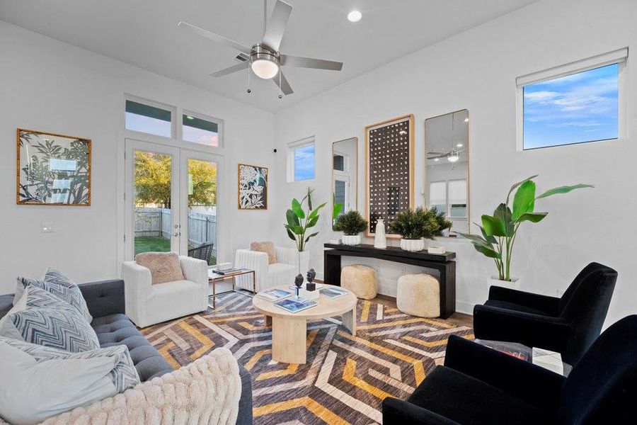 Living room with ceiling fan, plenty of natural light, french doors, recessed lighting, and wood finished floors