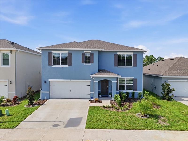 Front exterior of a new home in Edgemont at Serenoa, Clermont, FL, highlighting curb appeal (Image 23).
