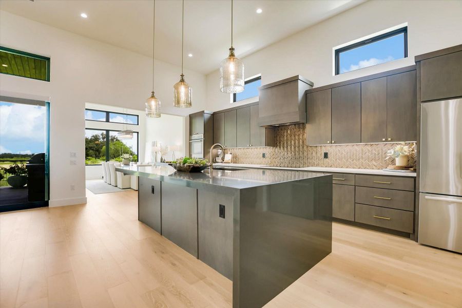 Experience modern living with high ceilings, an expansive kitchen island, and abundant natural light.