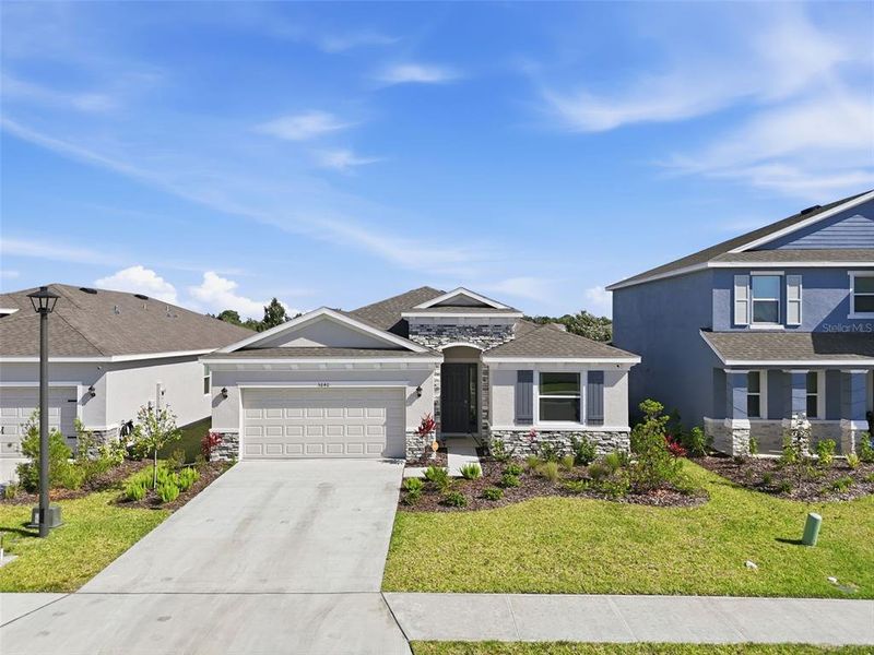 Front exterior of a new home in Silverstone North, Palmetto, FL, highlighting curb appeal (Image 23).
