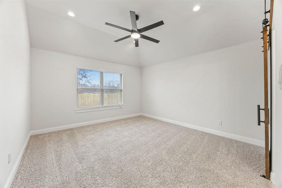 Empty room featuring light colored carpet, recessed lighting, and ceiling fan