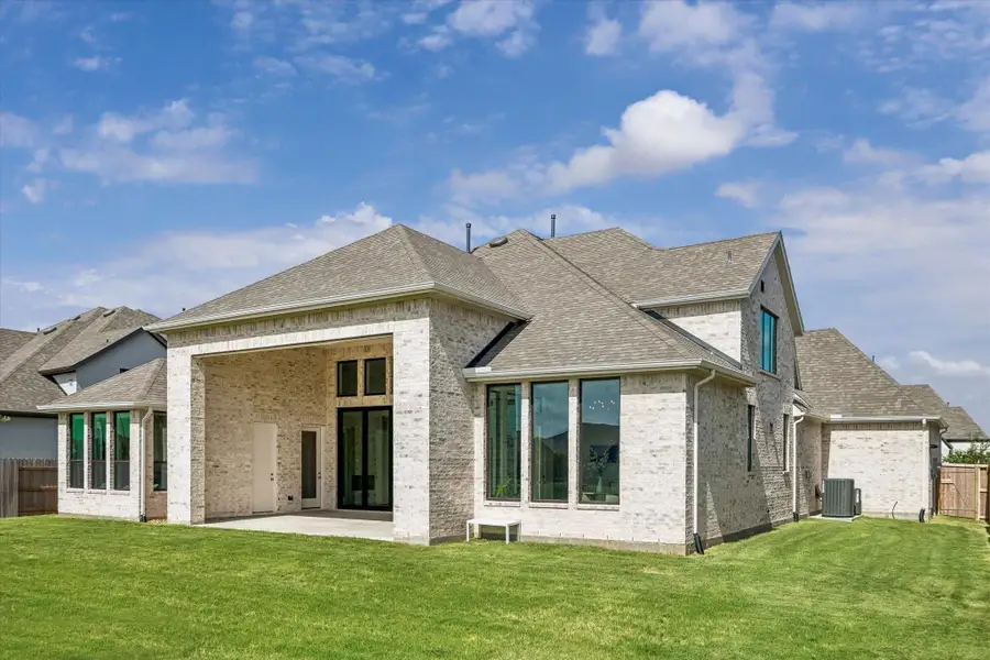 REAR EXTERIOR HIGHLIGHTS THE LIGHT BRICK FINISH, COVERED PATIO, TALL WINDOWS, AND LARGE BACKYARD. REAR EXTERIOR HIGHLIGHTS THE LIGHT BRICK FINISH, COVERED PATIO, TALL WINDOWS, AND LARGE BACKYARD.