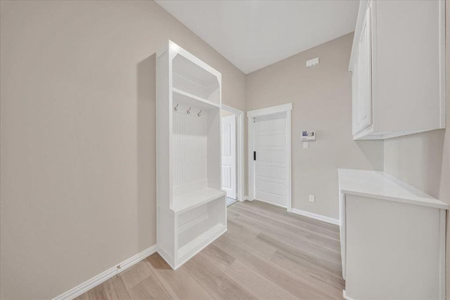 Mudroom featuring light wood-type flooring and baseboards Mudroom featuring light wood-type flooring and baseboards
