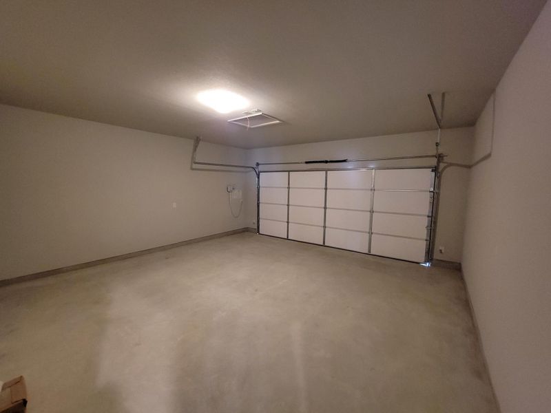 Garage featuring baseboards