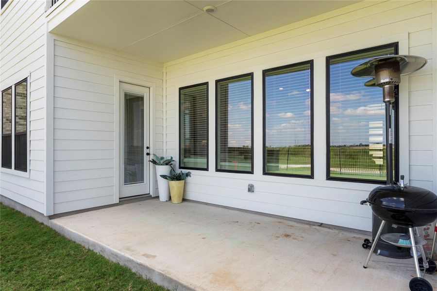 A spacious covered patio provides an ideal spot for outdoor living and entertaining, overlooking a verdant landscape. A spacious covered patio provides an ideal spot for outdoor living and entertaining, overlooking a verdant landscape.