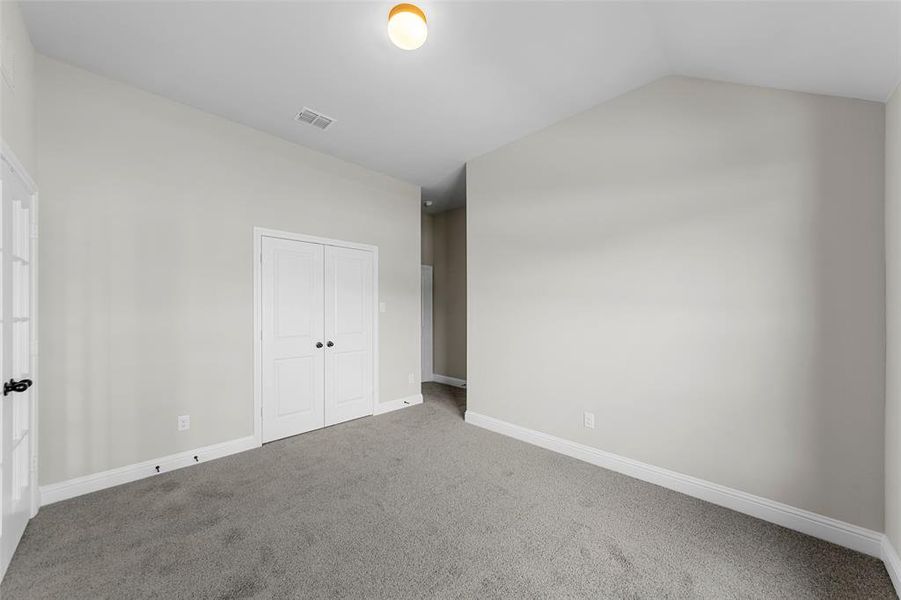 Unfurnished bedroom with carpet and a closet