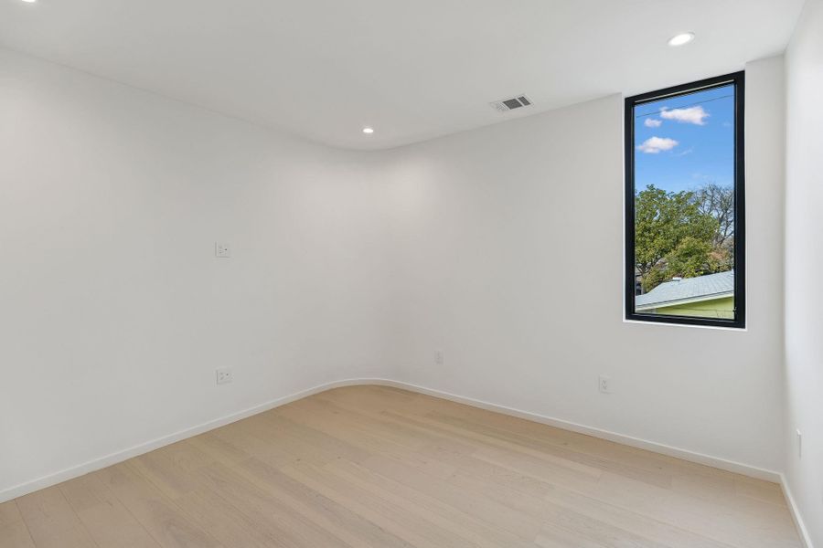 Bedroom #2 room with recessed lighting and light wood finished floors