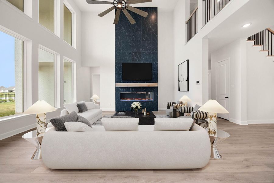 Another view of the magnificent family room, highlighting the spectacular floor-to-ceiling accent wall with a modern fireplace. This dramatic architectural centerpiece features a dark marble-look tile wrap that extends all the way to the soaring two-story ceiling, complemented by a rustic wood mantel. *Virtually Staged Another view of the magnificent family room, highlighting the spectacular floor-to-ceiling accent wall with a modern fireplace. This dramatic architectural centerpiece features a dark marble-look tile wrap that extends all the way to the soaring two-story ceiling, complemented by a rustic wood mantel. *Virtually Staged