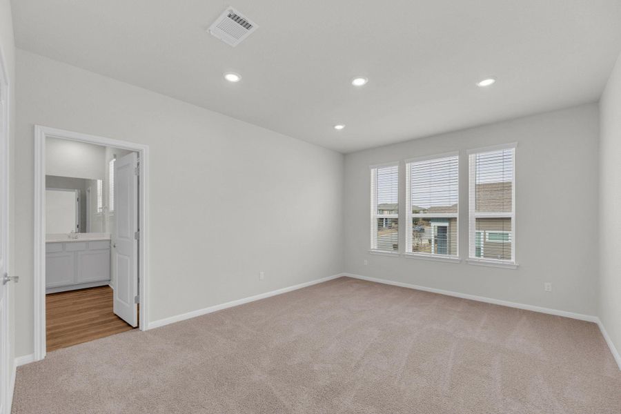 Empty room featuring light carpet and recessed lighting