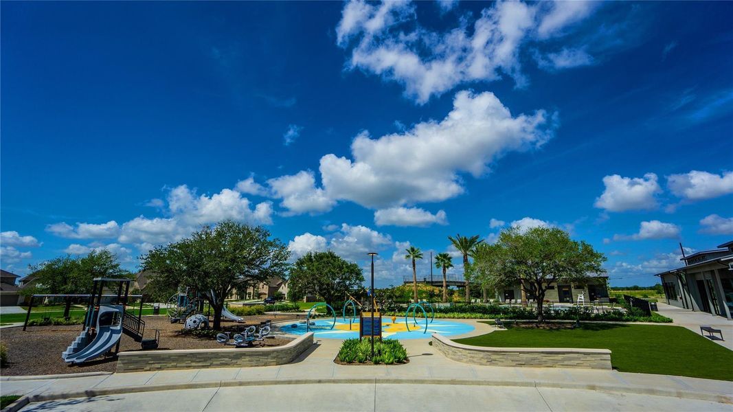 Watch little ones giggle and splash all day at the park-side splashpad while the surrounding green space invites neighborhood strolls and relaxed outdoor play.