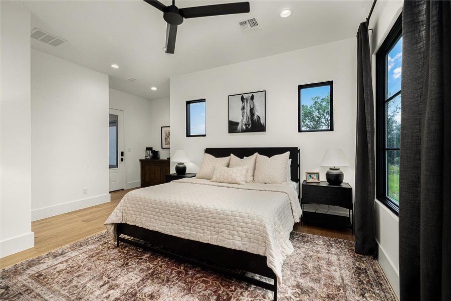 Bedroom featuring wood-type flooring and ceiling fan