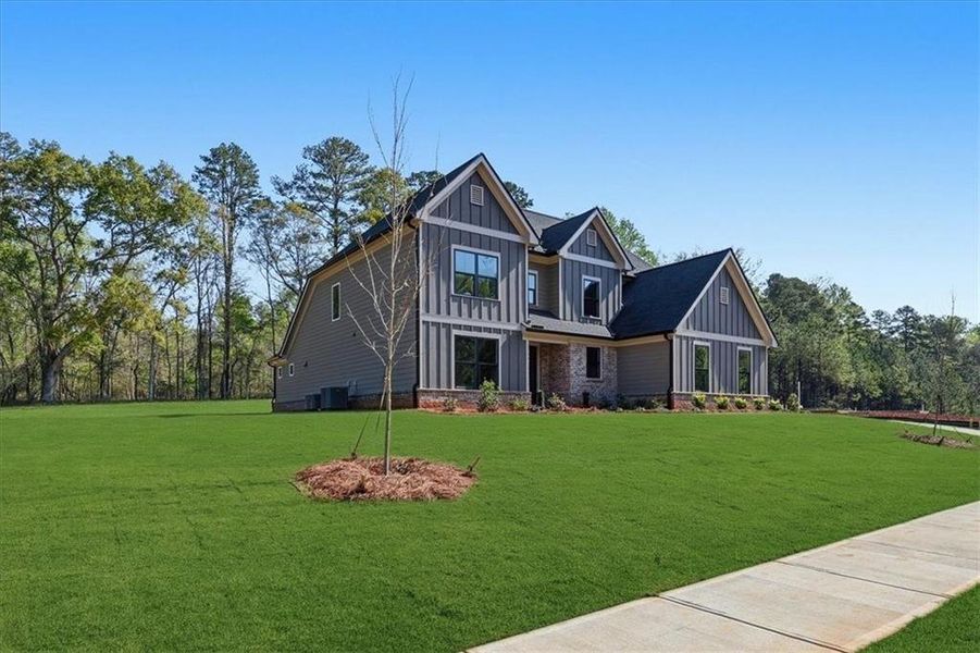 Front exterior of a new home in , Hoschton, GA, highlighting curb appeal (Image 33).