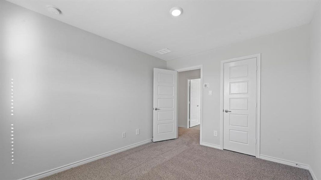 Unfurnished bedroom featuring carpet and baseboards Unfurnished bedroom featuring carpet and baseboards