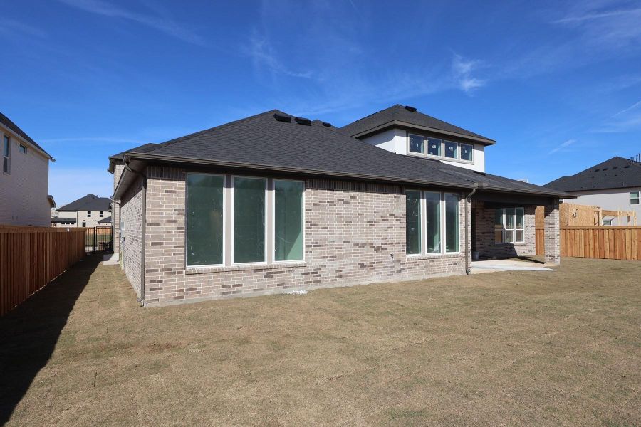 Exterior details and patio area of a home in Woodson’s Reserve, Spring (Image 3).