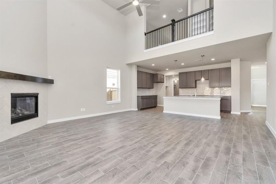 Take another glimpse into the heart of the home with this additional view of the family room—a sprawling space ready to accommodate all your gatherings. Sample photo of completed home with similar floor plan. As-built interior colors and selections may vary.