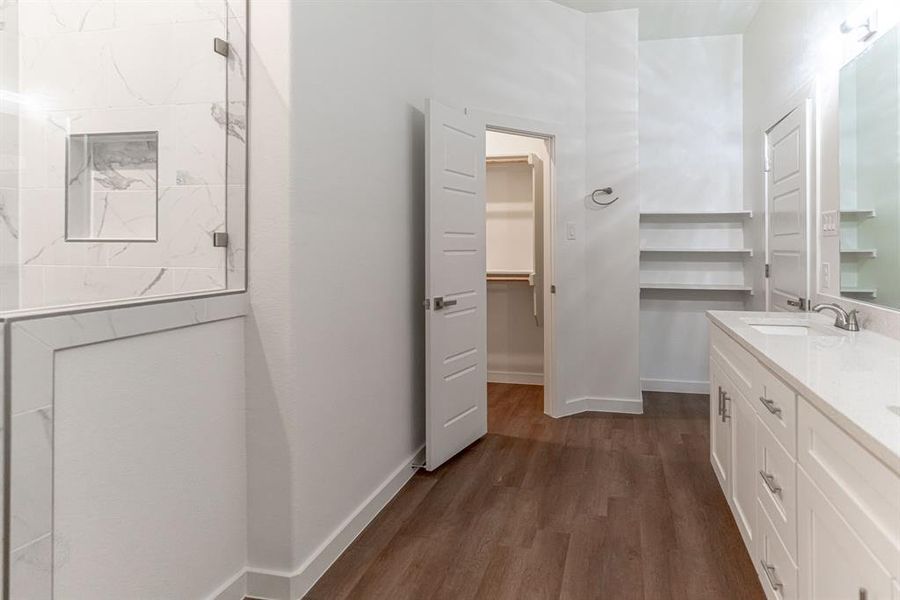 Primary bath with walk in closet and added shelving