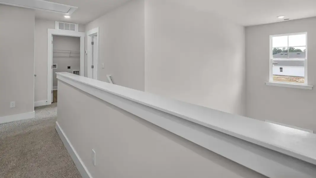 Representative unfurnished interior of a home built from the Forrester by D.R. Horton in The Highlands at Cedar Hill Landing, Navassa (Image 25).