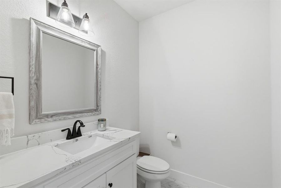 Bathroom with vanity and light marble finish floors