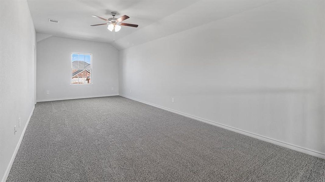 Bonus room featuring carpet floors, vaulted ceiling, and ceiling fan