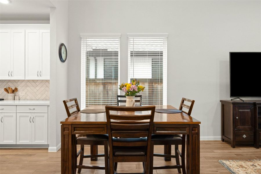 Large windows create a bright and cheerful space for everyday meals. Large windows create a bright and cheerful space for everyday meals.