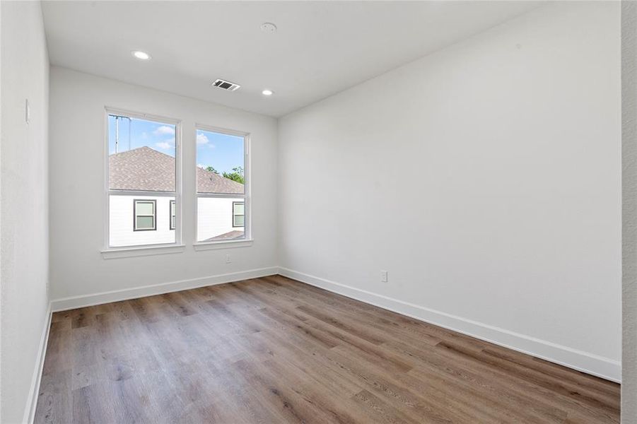 Enjoy an abundance of light even in the third guest bedroom, continuing the theme of  oversized windows found throughout the home.