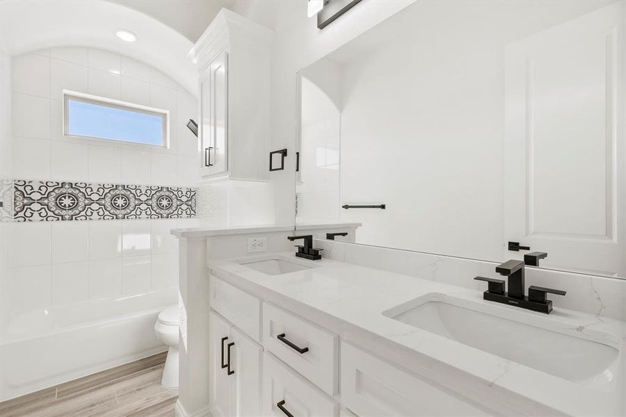 Full bathroom featuring custom flooring.