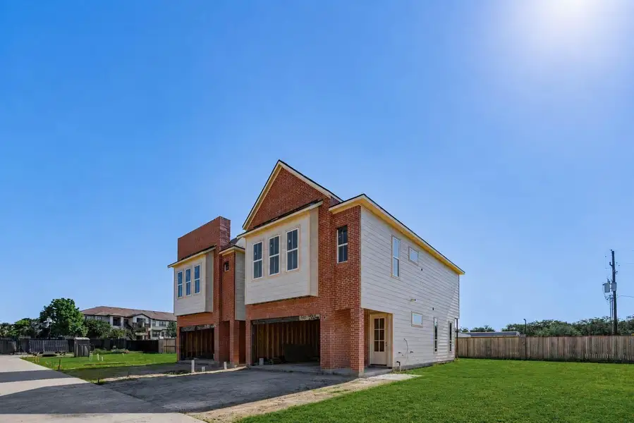 Side-angle exterior view capturing the home’s depth, modern rooflines, brick accents, light siding, attached garage, and generous green space along the side and rear. This perspective showcases the property’s new-construction setting, open surroundings, and contemporary design while giving buyers a broader view of the home’s exterior profile and lot placement. Side-angle exterior view capturing the home’s depth, modern rooflines, brick accents, light siding, attached garage, and generous green space along the side and rear. This perspective showcases the property’s new-construction setting, open surroundings, and contemporary design while giving buyers a broader view of the home’s exterior profile and lot placement.