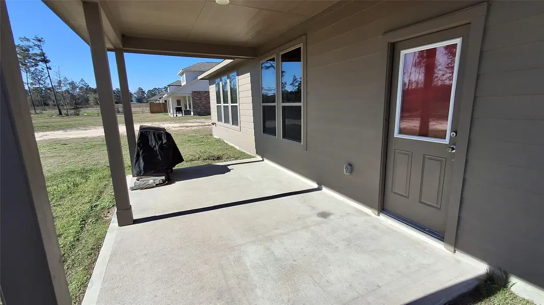 Front exterior of a new home in Pine Rock Estates, Conroe, TX, highlighting curb appeal (Image 1). Front exterior of a new home in Pine Rock Estates, Conroe, TX, highlighting curb appeal (Image 1).