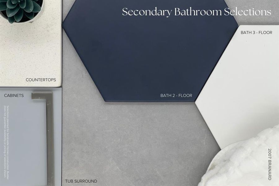 In the secondary bathrooms, cool and fresh vibes emerge as cabinets in Sherwin Williams "Online" and rich grey ceramic tile tub surrounds are paired with fun, large geometric floor tiles in crisp white and navy hues.