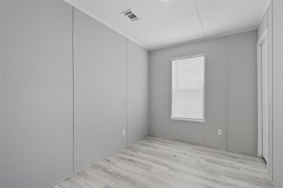 Unfurnished room featuring light wood-style floors Unfurnished room featuring light wood-style floors