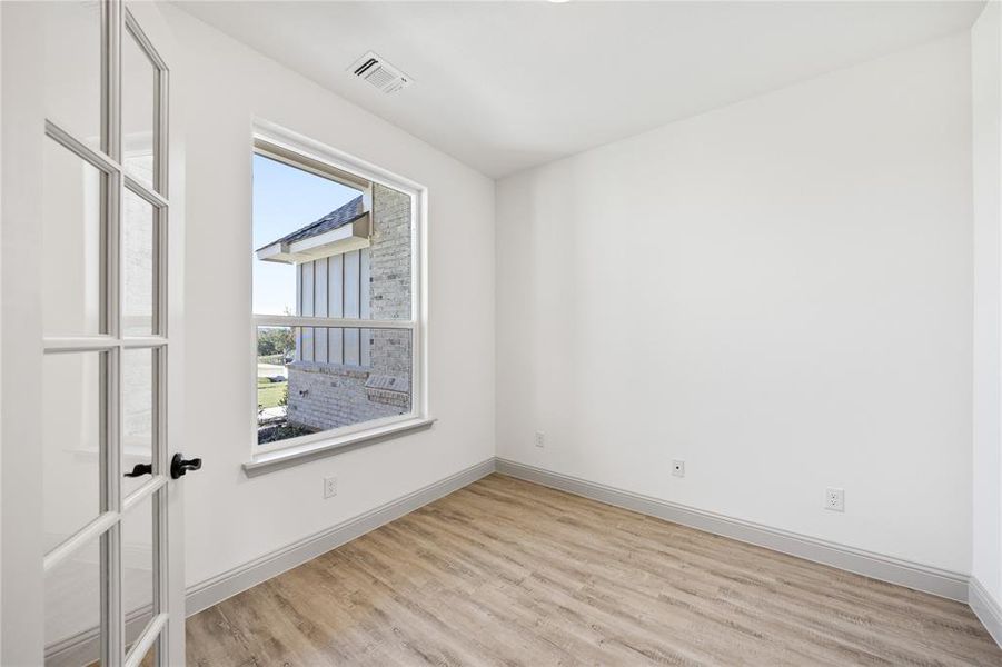 Empty room featuring light wood-style flooring and baseboards