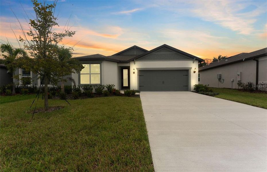 Front exterior of a new home in Oakfield Trails, Parrish, FL, highlighting curb appeal (Image 2).