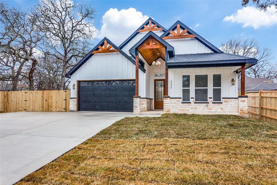 View of front of home featuring a garage and a front lawn