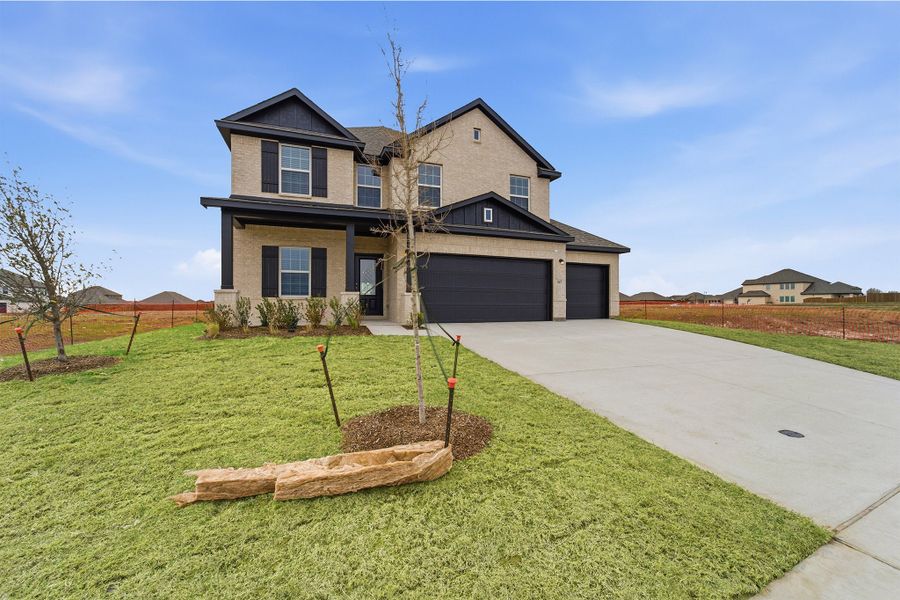 Front exterior of a new home in Saddlebrook Estates, Waxahachie, TX, highlighting curb appeal (Image 2).