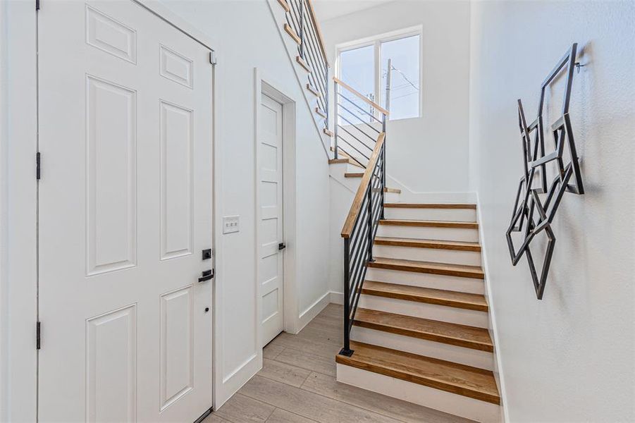 Stairs featuring wood finished floors and baseboards Stairs featuring wood finished floors and baseboards