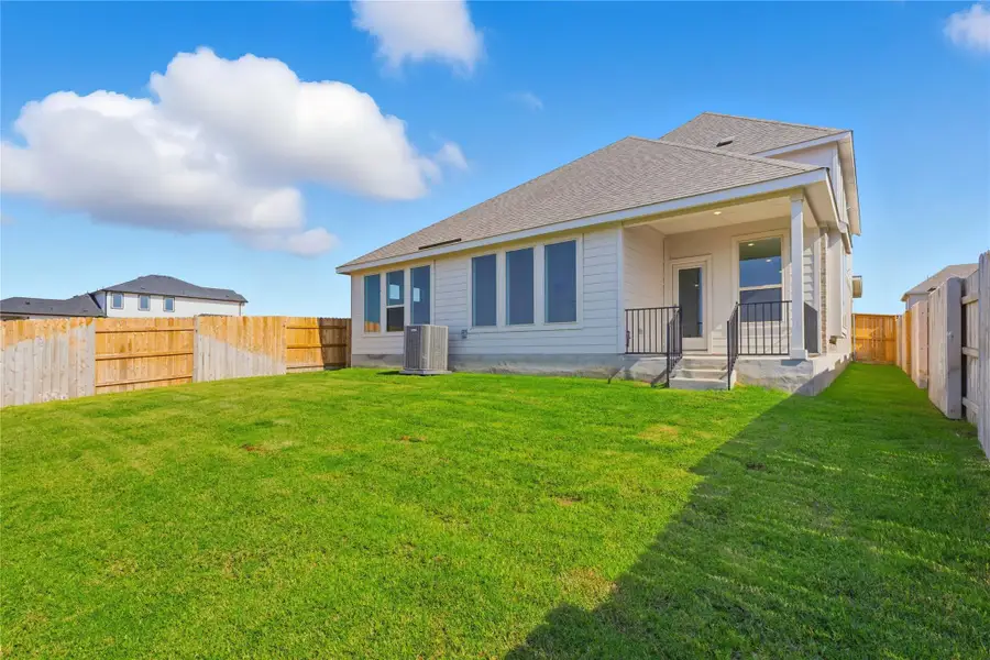 Rear view of house with a fenced backyard, roof with shingles, and a patio Rear view of house with a fenced backyard, roof with shingles, and a patio