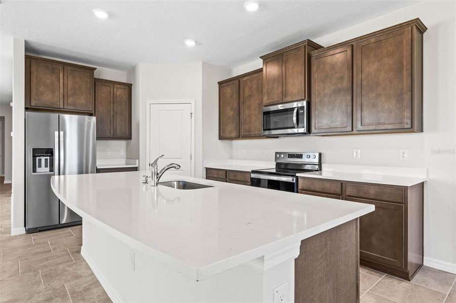 Kitchen has 42' crowned cabinetry and dinette space as well as island seating.