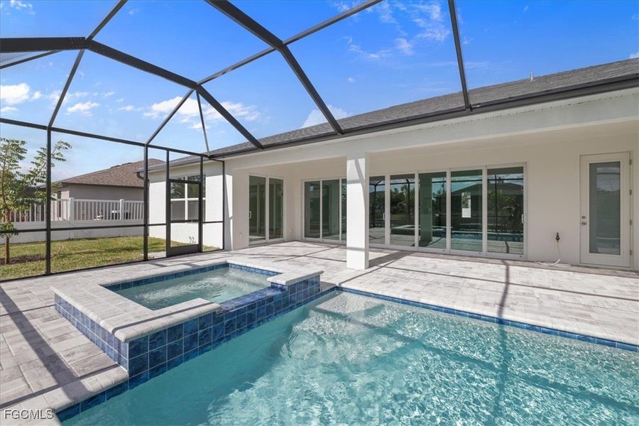 View of pool with a sunroom, a patio area, a lanai, and a pool with connected hot tub