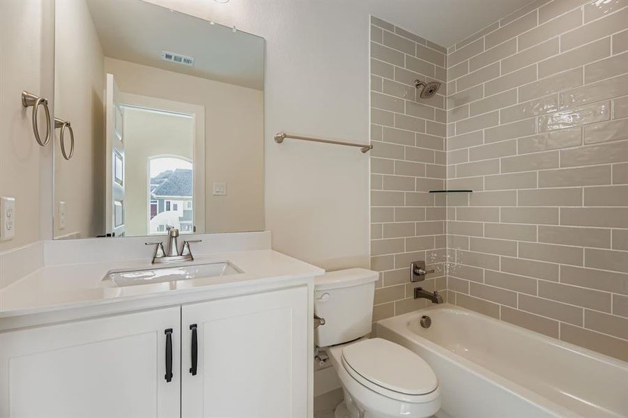 Bathroom featuring bathing tub / shower combination and vanity