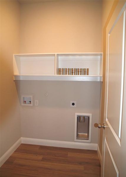 Clothes washing area featuring hookup for a washing machine, gas dryer hookup, dark wood-type flooring, and hookup for an electric dryer