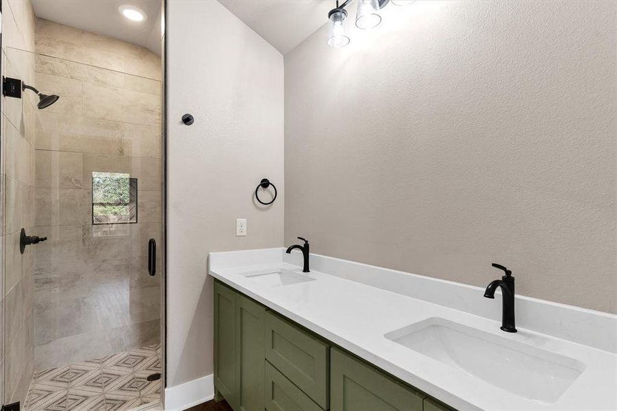 Full bathroom featuring double vanity and a stall shower Full bathroom featuring double vanity and a stall shower