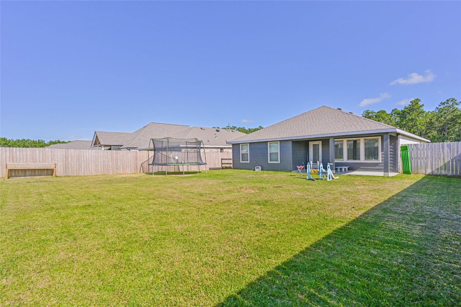 Huge fenced backyard with plenty of room for pets, kids, a future garden, or outdoor living upgrades.