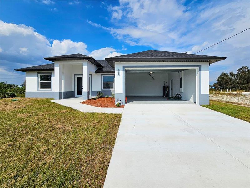 Front exterior of a new home in , Lehigh Acres, FL, highlighting curb appeal (Image 17).