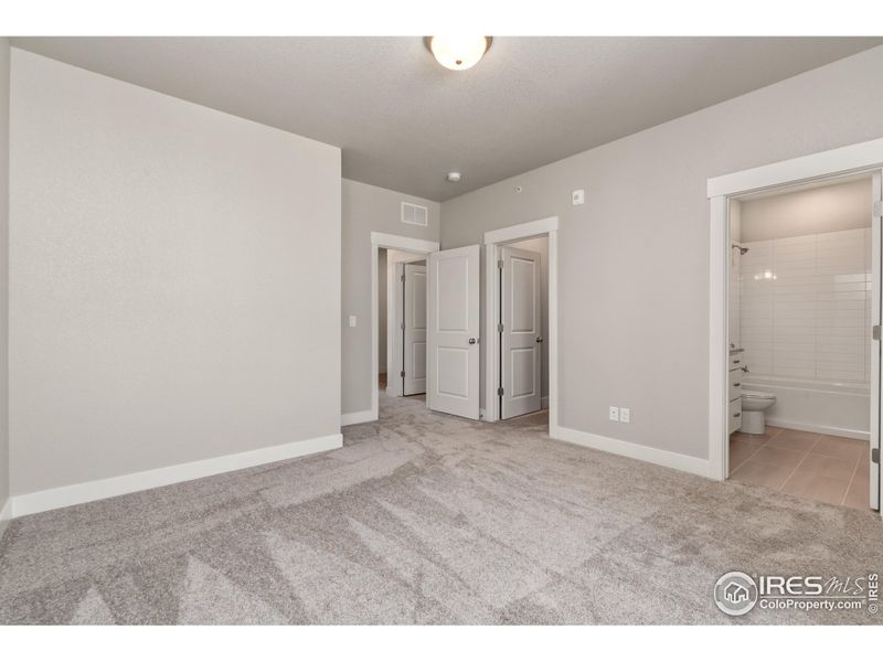 Second bedroom showing attached bathroom & walk-in closet