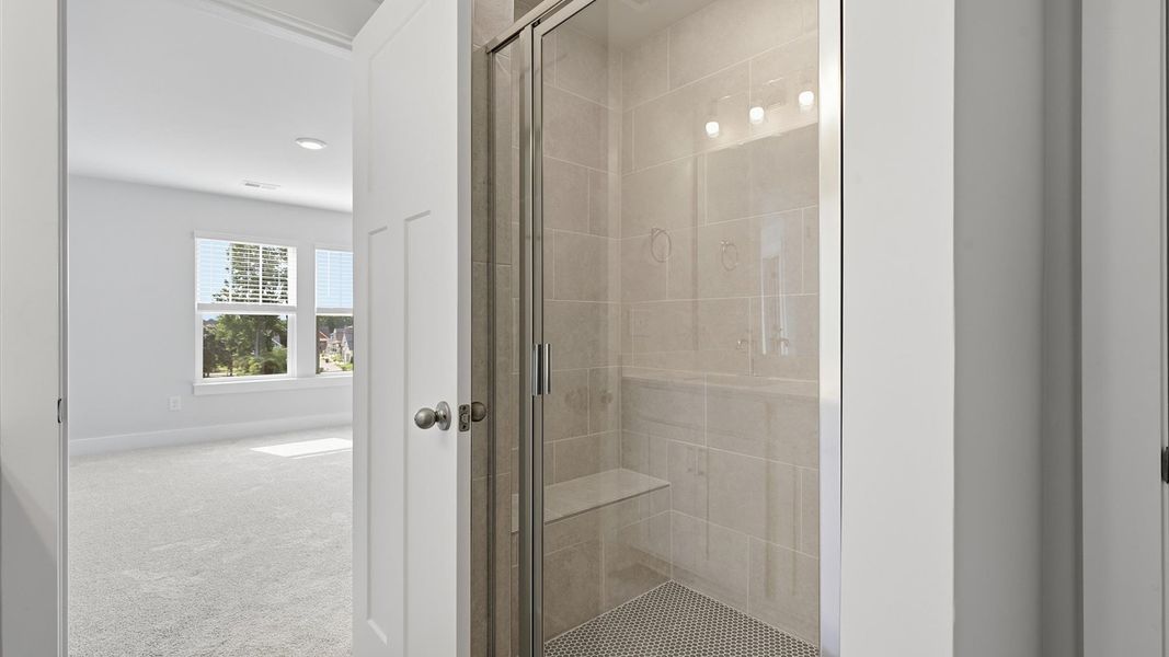 Memorable mornings begin in this elegant primary bathroom with walk-in shower and good lighting located in Simpsonville, SC